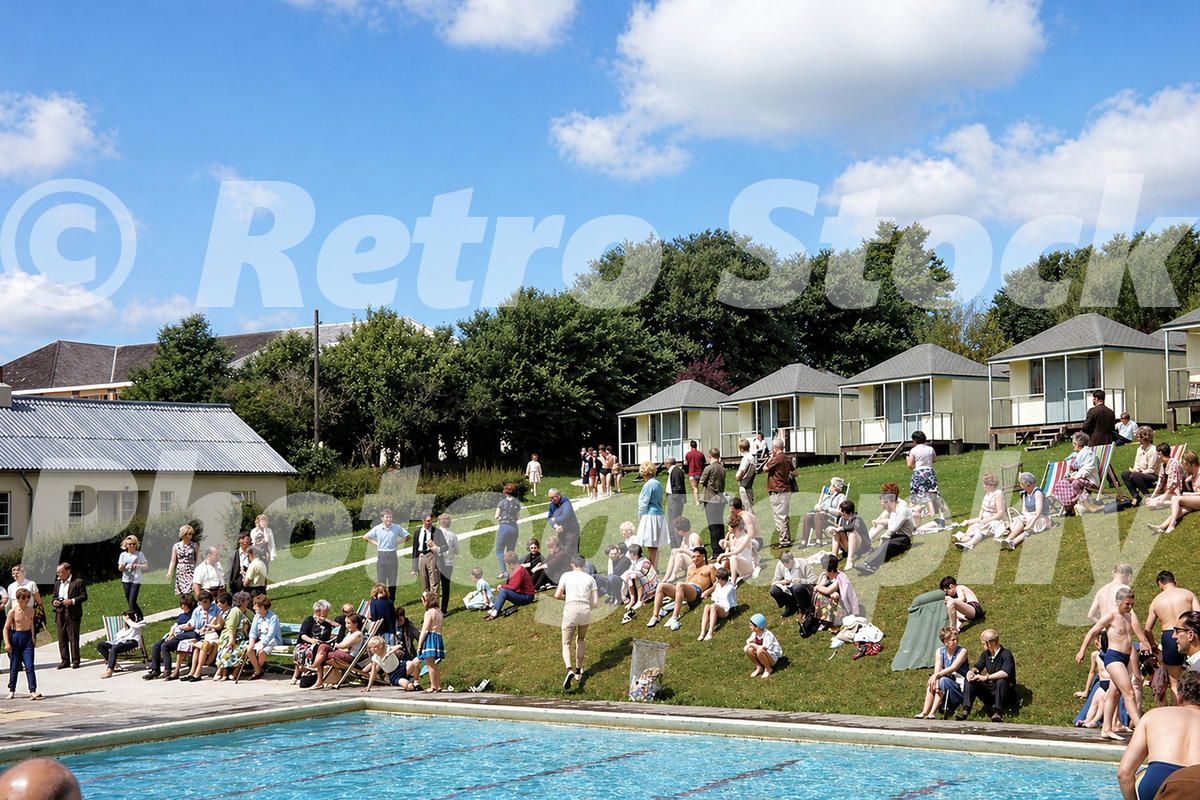 Pontins Dolphin Holiday Camp at Brixham in the 1960s with outdoor pool, hillside crowd, deckchairs and chalet blocks
