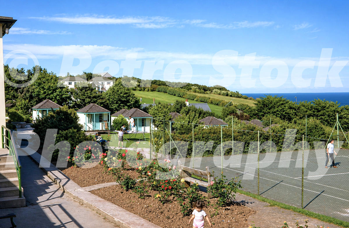 Pontins Dolphin Holiday Camp at Brixham in the 1960s with chalet blocks, tennis court, gardens and sea view