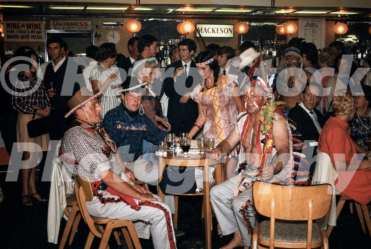 Pontins South Devon Holiday Camp at Paignton in the 1960s with fancy dress costumes, Mackeson bar sign and crowded evening entertainment room
