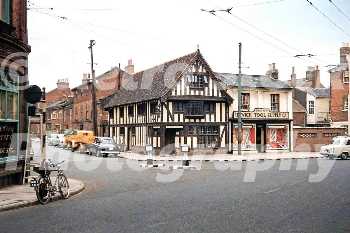 1950s view of Princes Street and Friars Street in Ipswich, with a timber-framed building, Ipswich Tool Supply Co., cars, trolleybus wires and a bicycle.