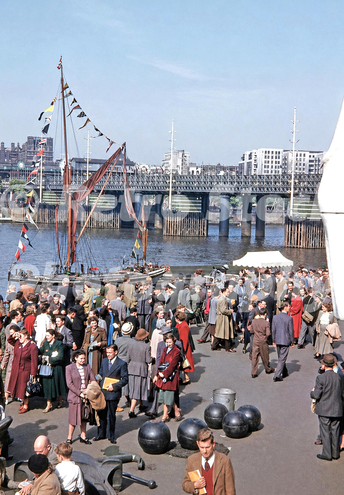 river-thames-and-south-bank-festival-of-britain-1951_55239671715_o Genuine colour 1950s photograph of crowds at the Festival of Britain South Bank Exhibition in London, beside the River Thames with a decorated sailing boat and bridge in the background.