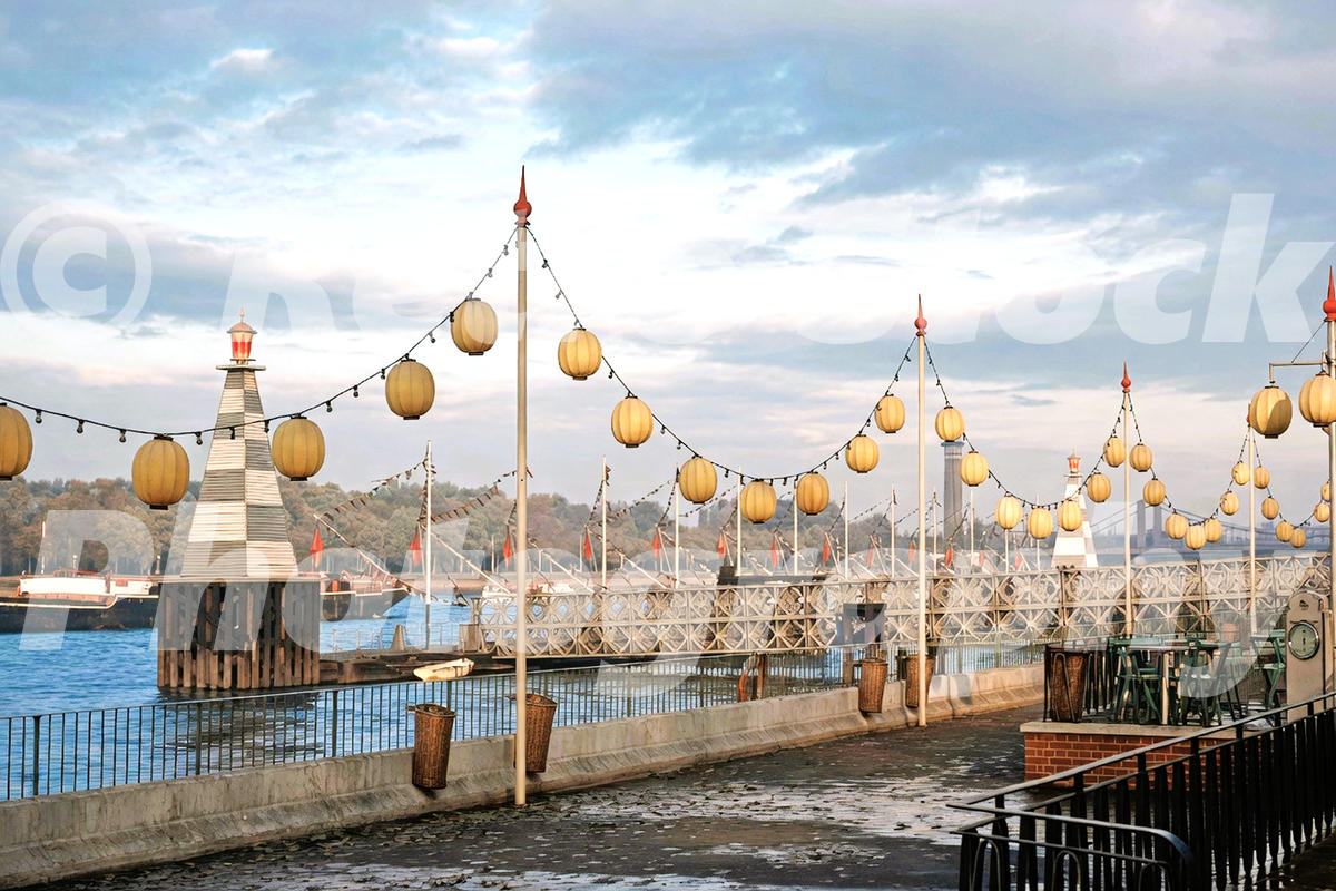 1950s colour view of Festival of Britain decorations beside the River Thames in London, with lanterns, lights, flagpoles and riverside walkways.