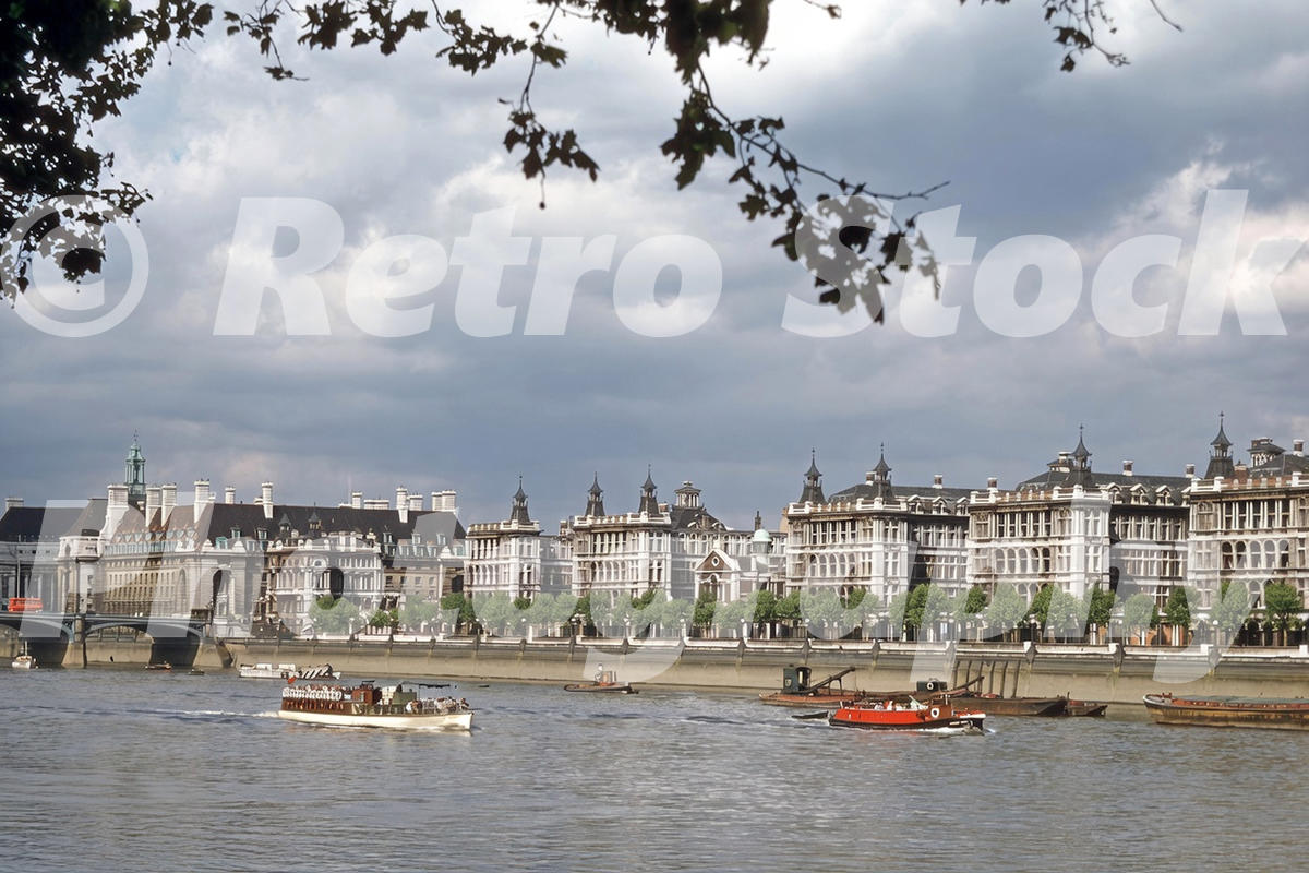 1950s view of the River Thames from Victoria Tower Gardens, with Westminster Bridge, County Hall, St Thomas’s Hospital, boats and barges.