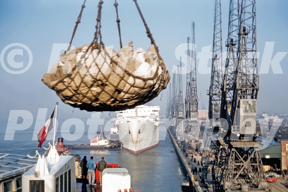 1960s view of mailbags being unloaded from the SS France at Southampton Docks, with cranes and the RMS Andes in the background.