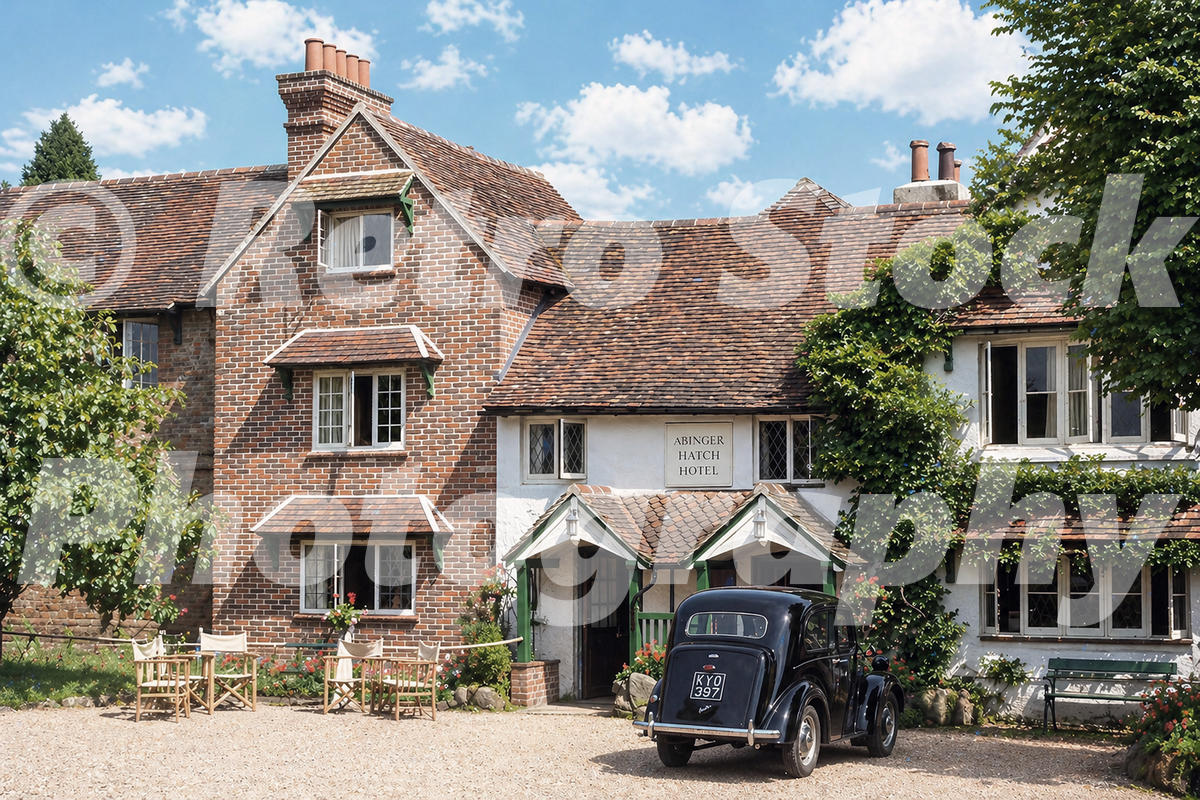 1950s view of the Abinger Hatch Hotel at Abinger Common in Surrey, with a black car, garden seating and traditional country inn frontage.