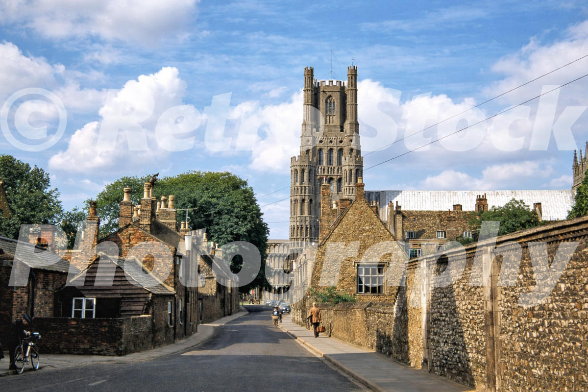 1950s colour photo of The Gallery in Ely, Cambridgeshire, looking along a narrow street towards Ely Cathedral tower.
