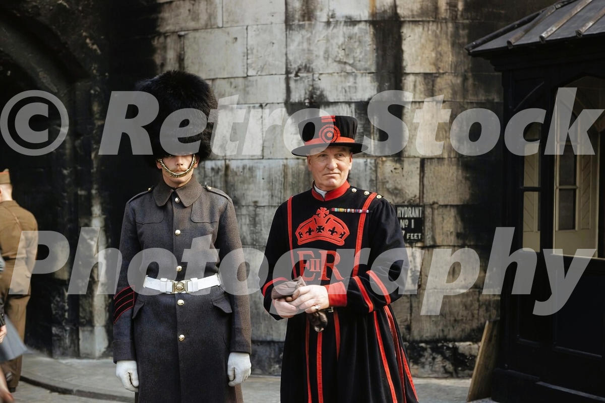 A 1950s colour photo of a Yeoman Warder and a Coldstream Guard in a grey greatcoat at the Tower of London in 1956.