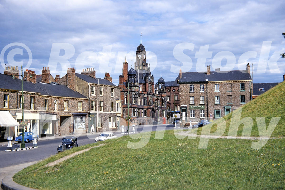 Tower Street in York in the 1950s with Magistrates’ Court clock tower and parked cars