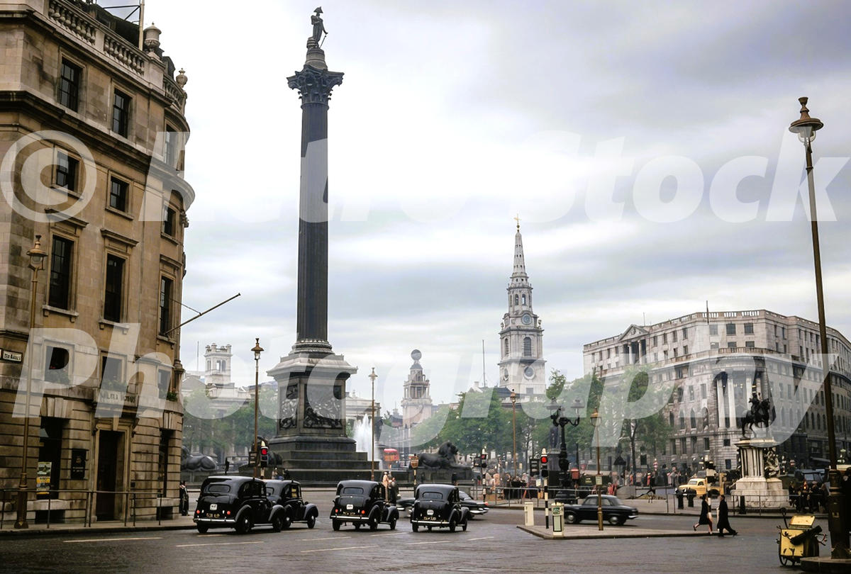 1950s colour photo of Trafalgar Square in London, with Nelson’s Column, St Martin-in-the-Fields, black taxis and South Africa House.