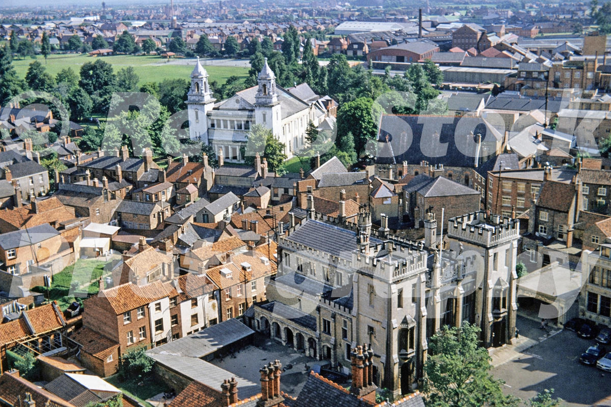 1950s colour photo from St Botolph’s Church tower in Boston, Lincolnshire, looking over rooftops towards Boston Sessions House and surrounding town buildings.