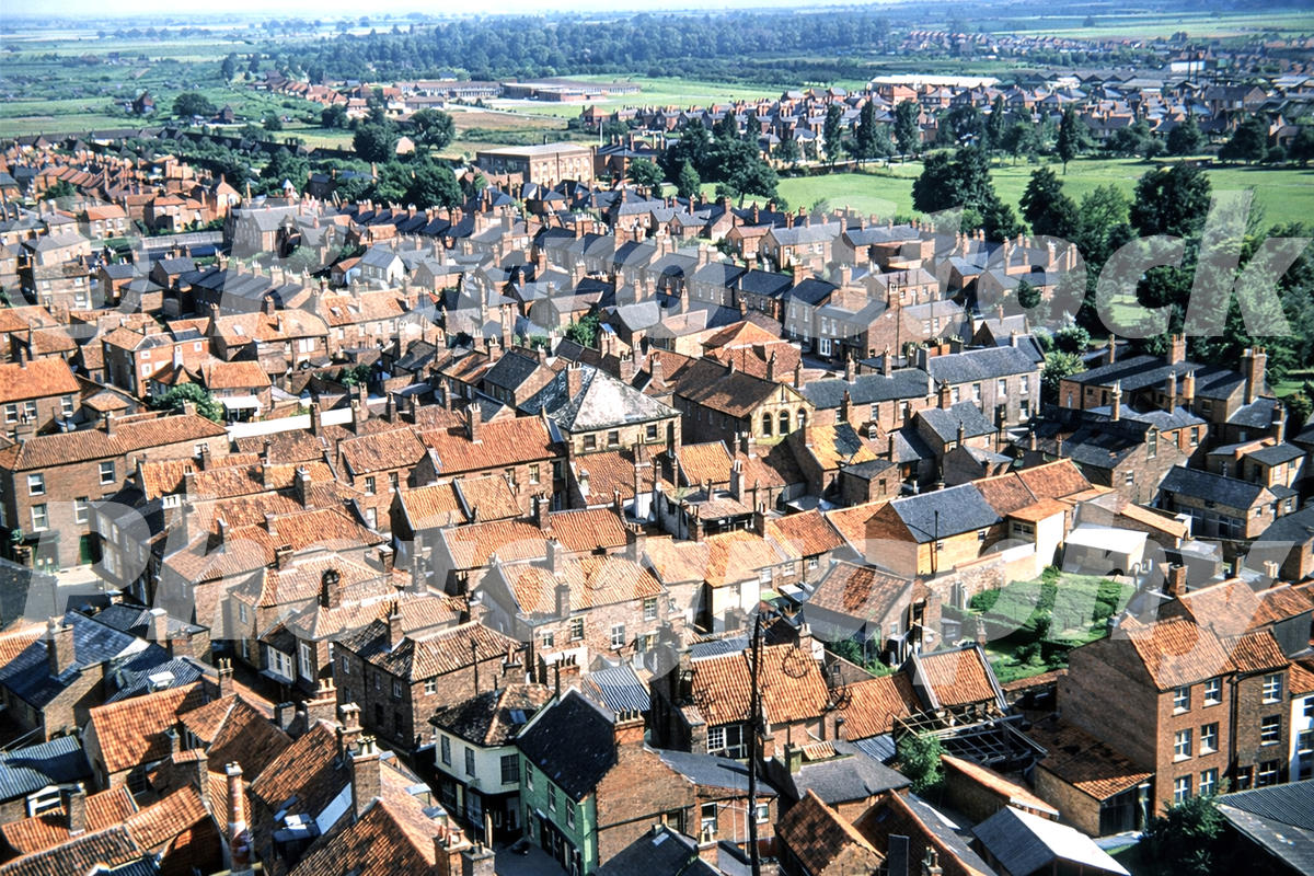 1950s colour photo of Boston, Lincolnshire, seen from St Botolph’s Church tower, looking over red-roofed houses towards open fenland.