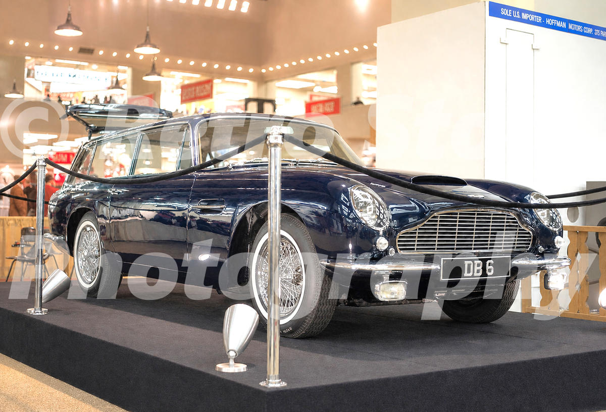 A 1960s colour photo of a black Aston Martin DB6 Vantage Shooting Brake on a raised display at the 1966 New York Auto Show.