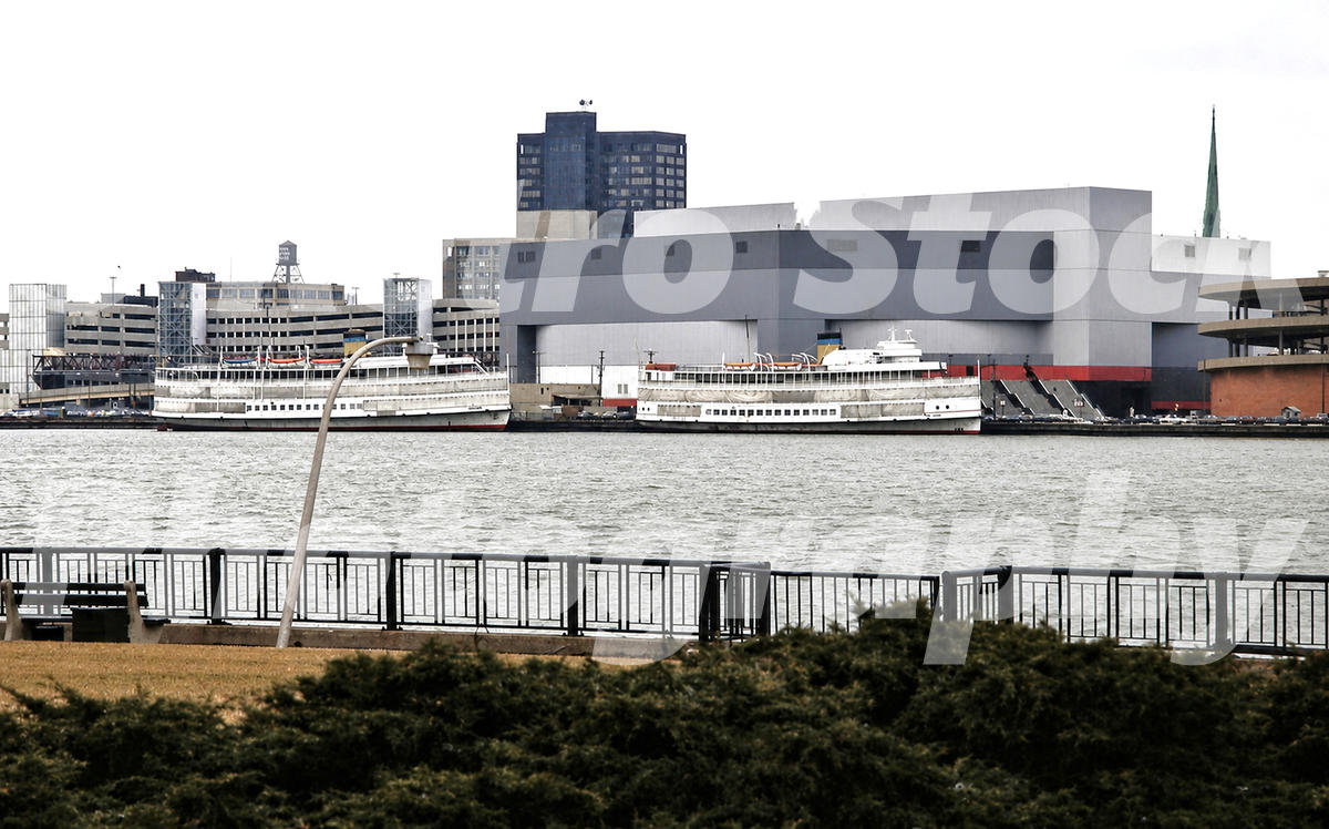 A 1980s color photo of the SS Columbia and SS Ste. Claire Boblo boats docked on the Detroit River in front of the Joe Louis Arena in Detroit, Michigan in 1981.