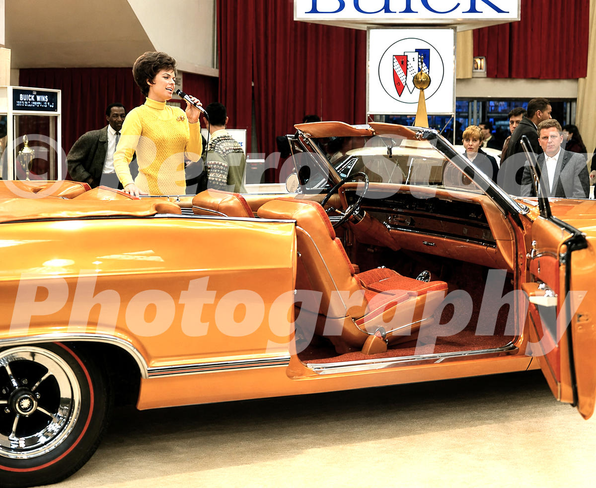 1960s color view of a Buick LeSabre Custom Convertible at the New York Auto Show, with a presenter, Buick signage and show visitors.
