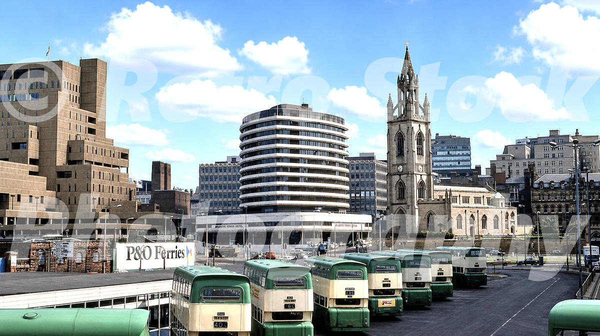 1980s view of Pier Head bus station in Liverpool, with green and cream buses, P&O Ferries sign, Atlantic Tower Hotel and the Church of Our Lady and St Nicholas.