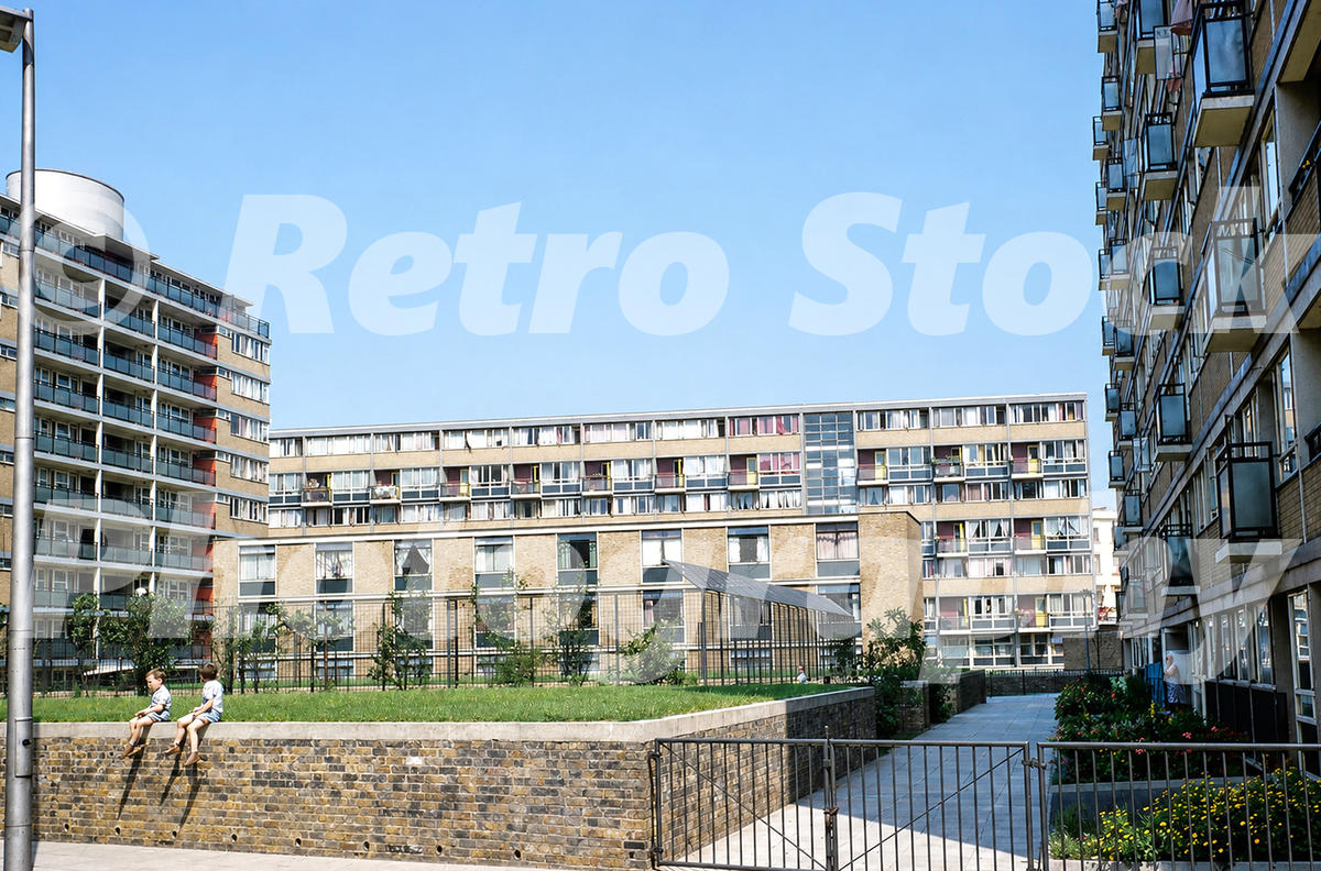 churchill-estate-pimlico-london-1950s_55259780872_o A 1950s colour photo of the completed residential blocks at Churchill Gardens Estate in Pimlico, featuring mid-century brickwork, expansive balconies, and children sitting on a low wall.