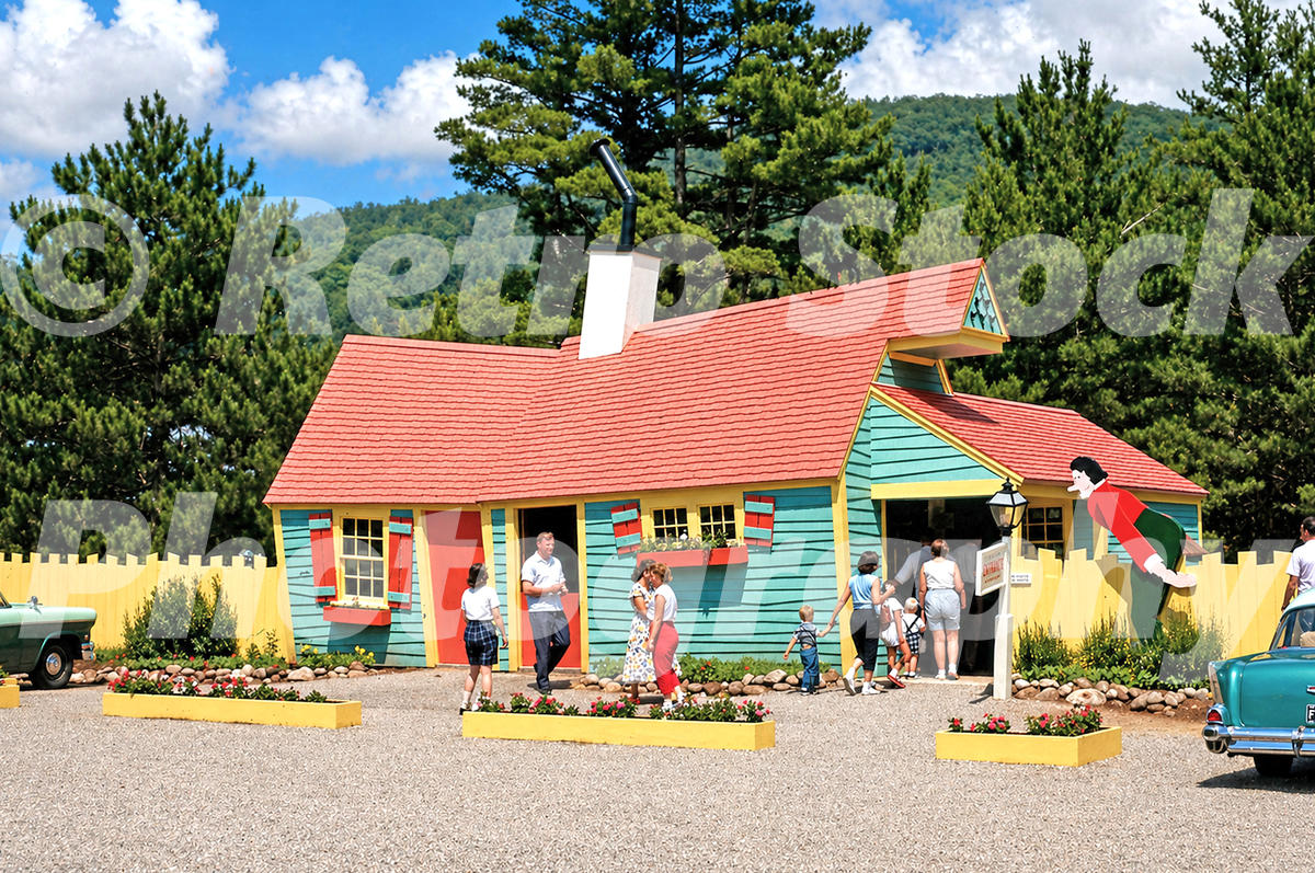 1950s color view of the Crazy House at Story Land in Glen, New Hampshire, with families, period cars and wooded mountains behind.
