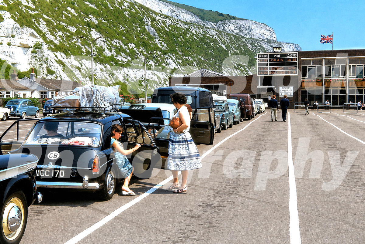 1960s view of Dover ferry terminal, with cars queueing for cross-Channel ferries to Calais, Ostend and Boulogne beneath the white cliffs.