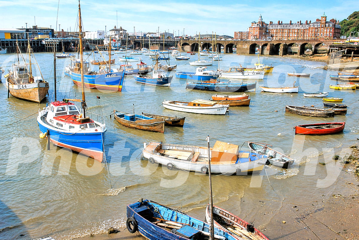 1970s photo of boats moored in Folkestone Harbour with the Royal Pavilion Hotel in the background