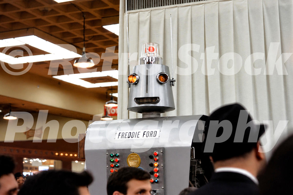 A 1960s color photo of "Freddie Ford," a 9-foot-tall promotional robot made of car parts, on display at the 1966 New York Auto Show.