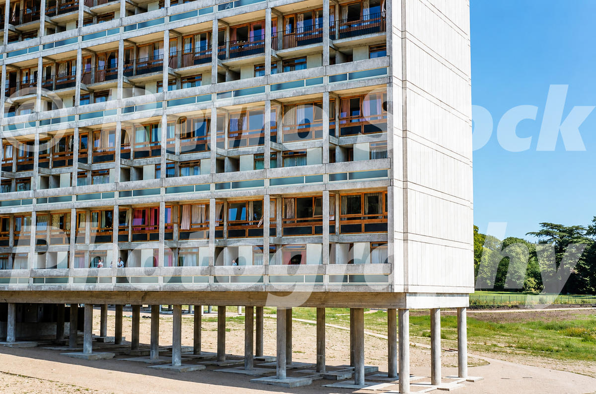 A 1950s colour photo of a newly finished modernist apartment block at Highcliffe Drive on the Alton Estate, showing the concrete structure raised on pilotis with residents visible on their balconies.