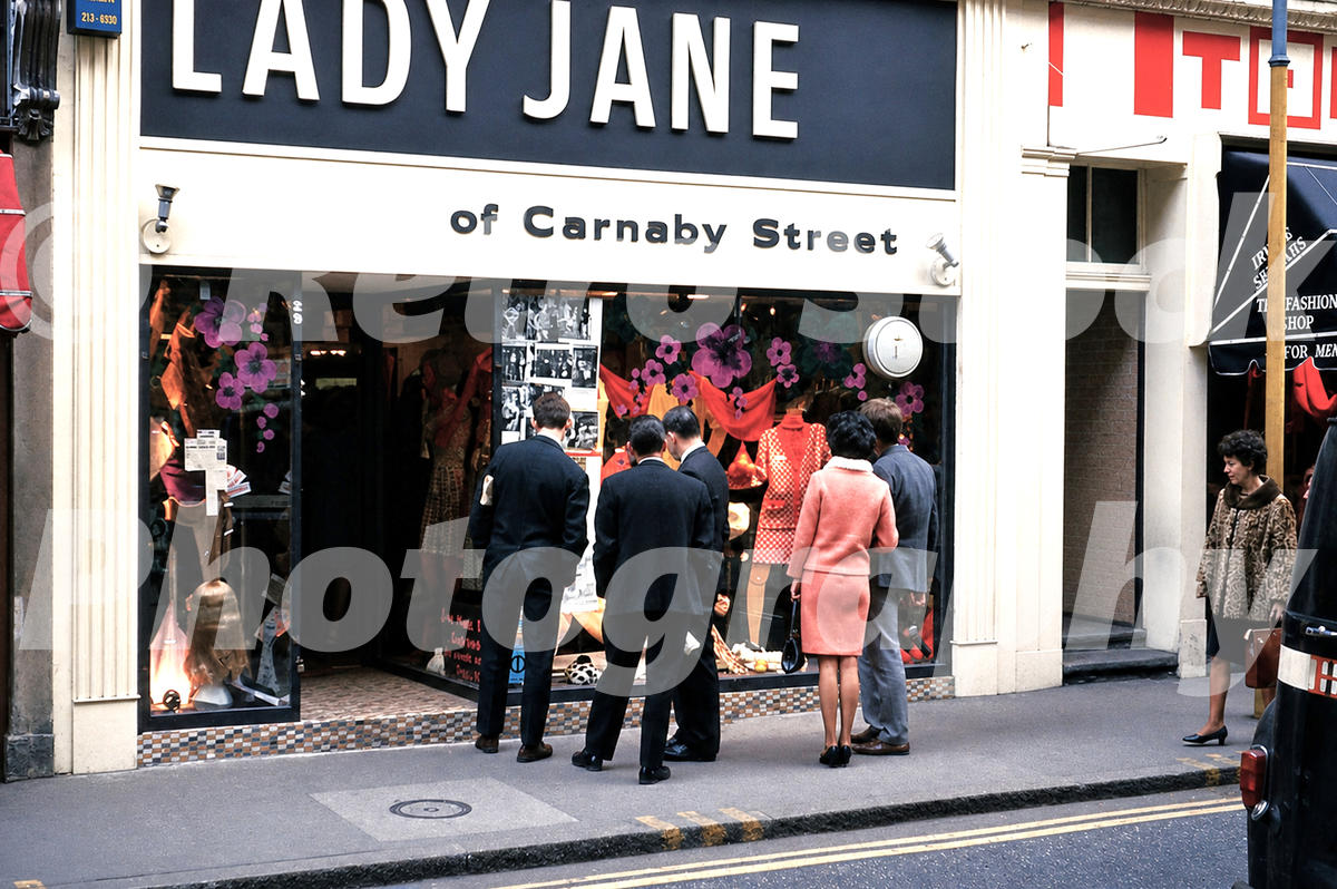 A 1960s colour photo of a group of people gathered outside the Lady Jane boutique on Carnaby Street in 1966.