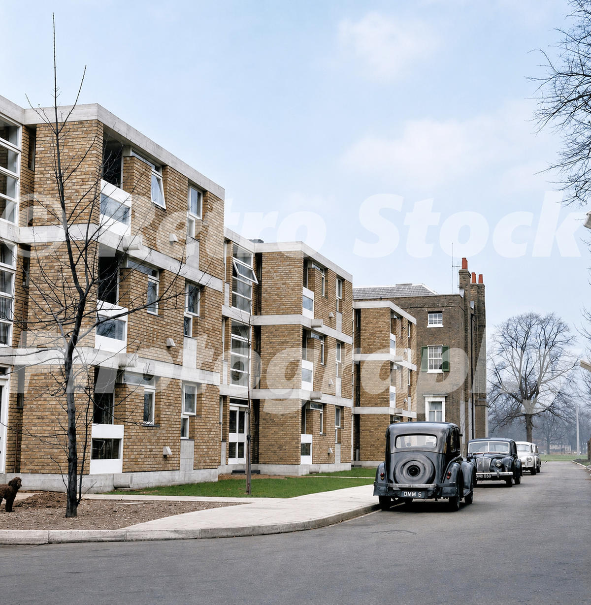 1960s view of Langham House Close in Richmond, Surrey, with modern brick and concrete apartment blocks, parked cars and older houses beyond.