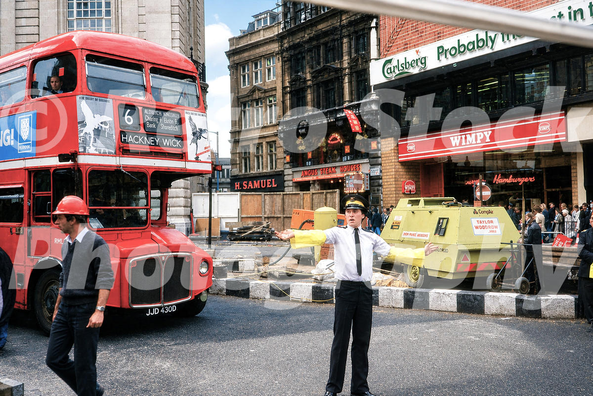 old photo of Piccadilly Circus in London in the 1980s with a Routemaster bus, roadworks and Wimpy