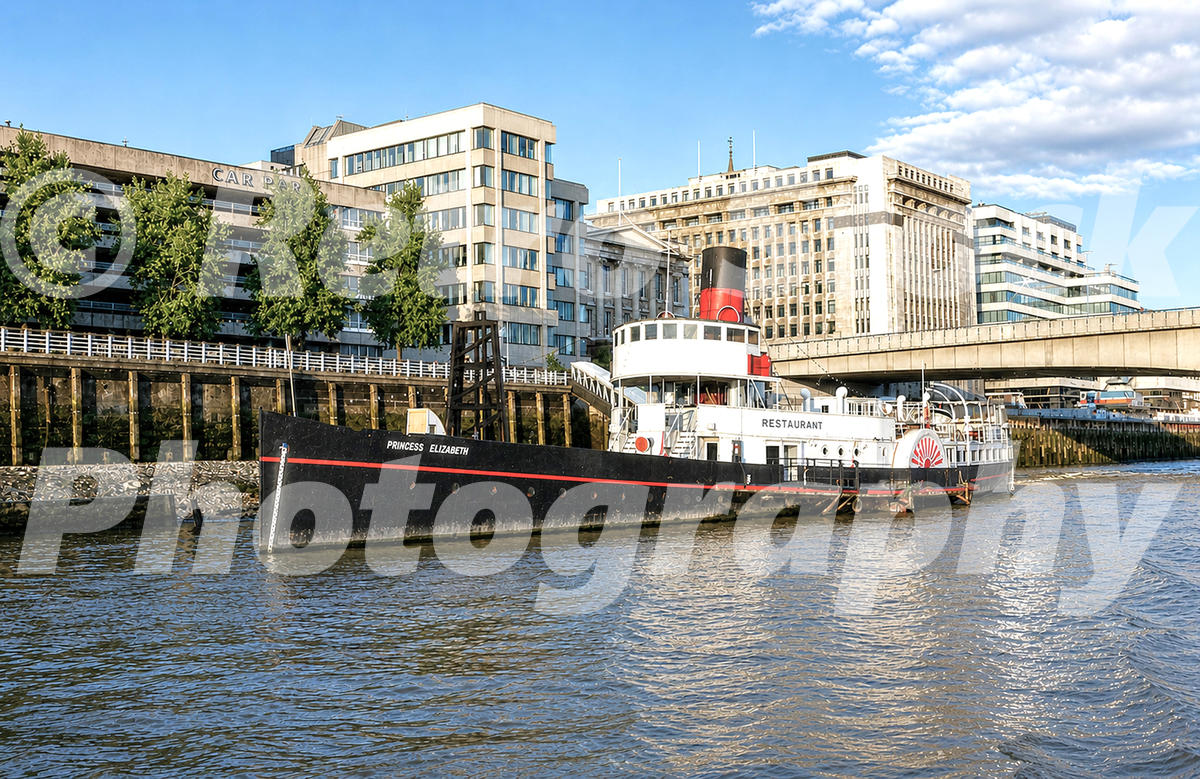 princess elizabeth, river thames london 1980s photo of the paddle steamer Princess Elizabeth on the River Thames in London, moored west of London Bridge with office blocks and a riverside roadway behind.