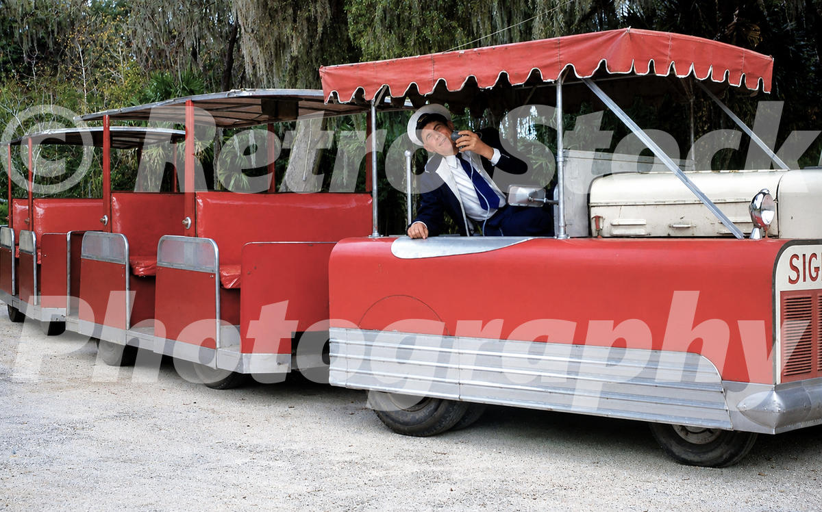 road-train-at-weeki-wachee-springs-florida-1950s_55261066835_o 1950s color view of a red road train at Weeki Wachee Springs in Florida, with open passenger trailers, a uniformed driver and trees with Spanish moss.