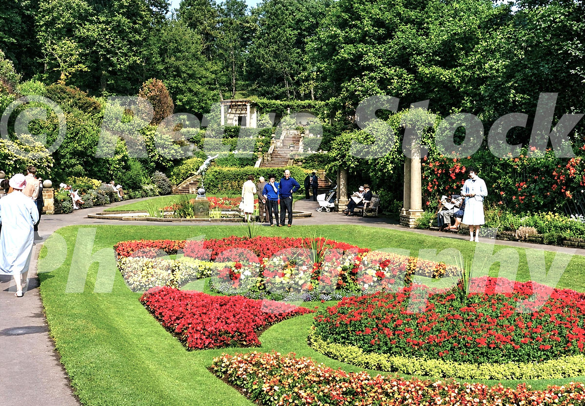 1960s view of South Cliff Gardens in Scarborough, with formal flower beds, clipped lawns, paths, benches and visitors.