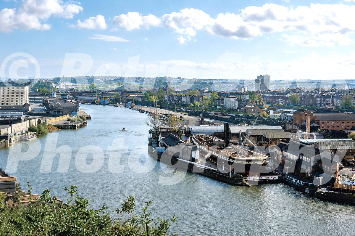 A 1970s photograph of the SS Great Britain in the Great Western Dockyard, Bristol, viewed from a high vantage point overlooking the River Avon and the industrial cityscape.