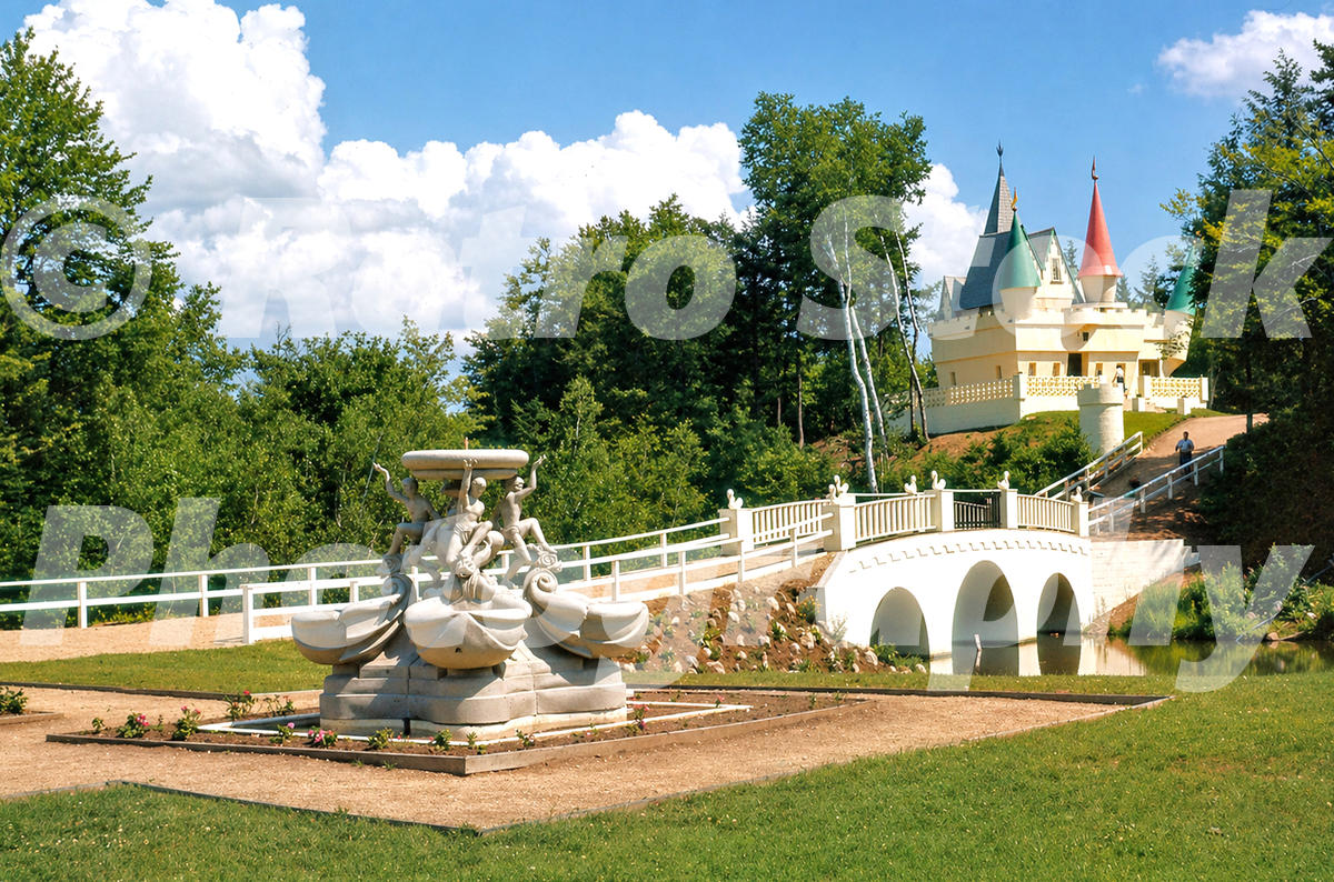 1950s color view of Story Land in Glen, New Hampshire, with a fairy-tale castle, ornamental bridge, fountain and landscaped gardens.