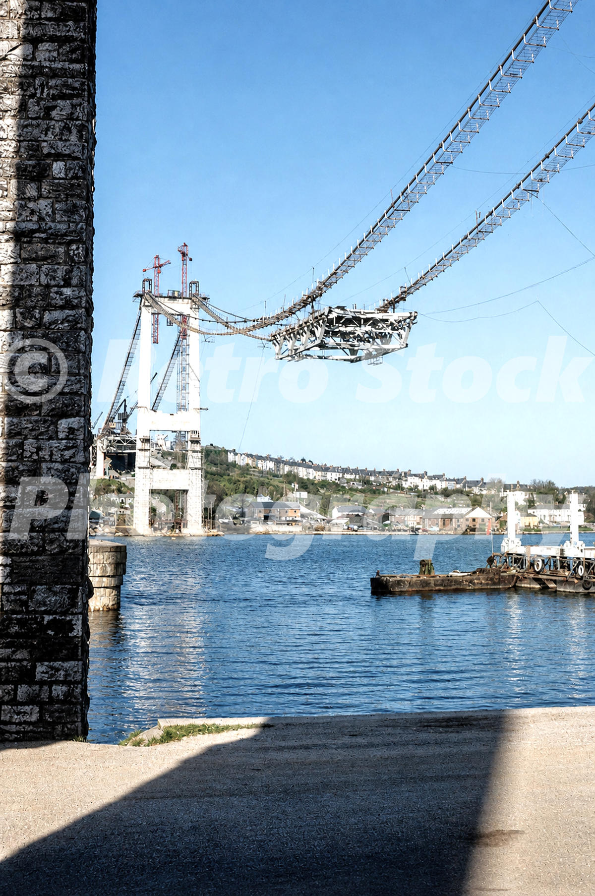 Tamar Bridge under construction around 1959, showing suspended roadway sections over the River Tamar