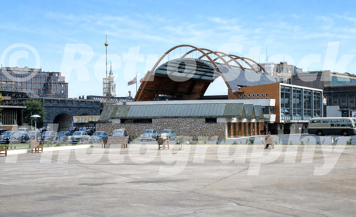 A 1950s colour photo of the rear of the Waterloo Air Terminal on the South Bank, showing the parabolic arched roof and the helipad area.